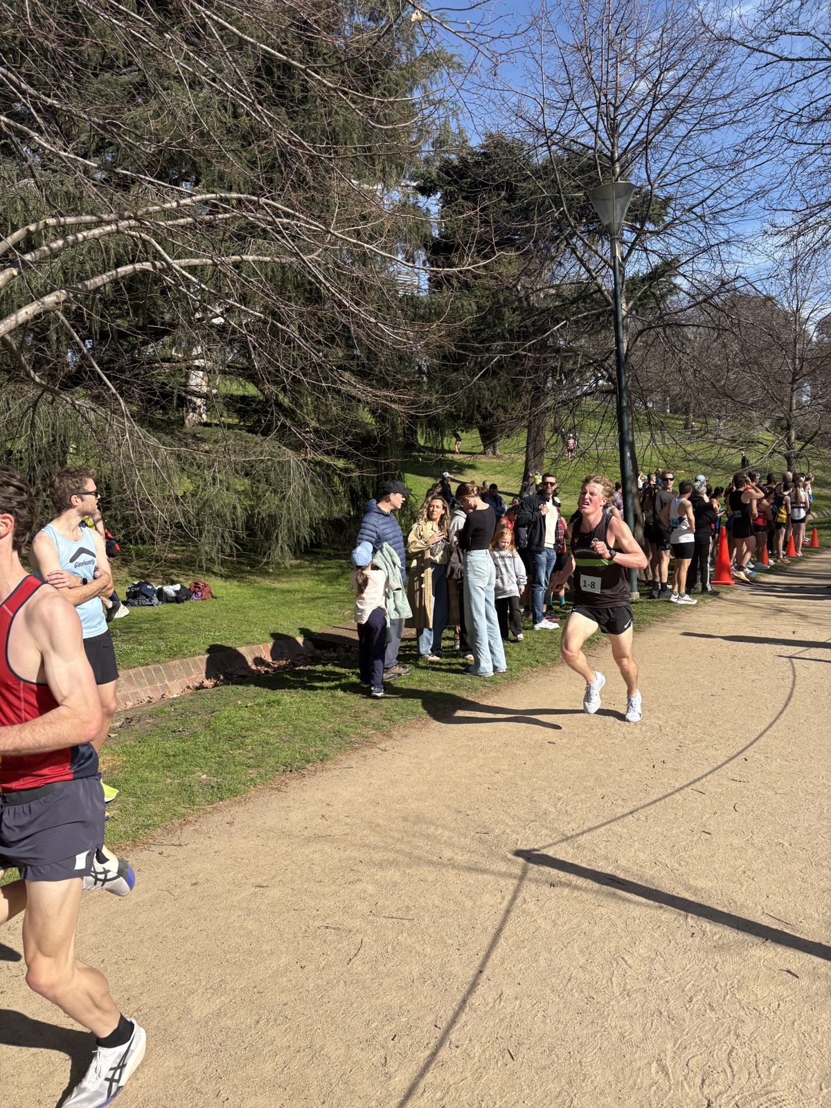 A Sandringham runner on the Tan circuit with spectators lining the path