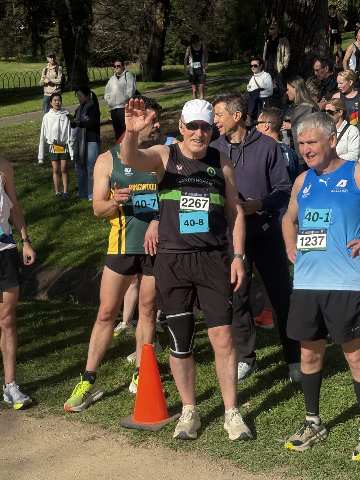 Masters athletes from several clubs waiting in the changeover area at the Tan Relays