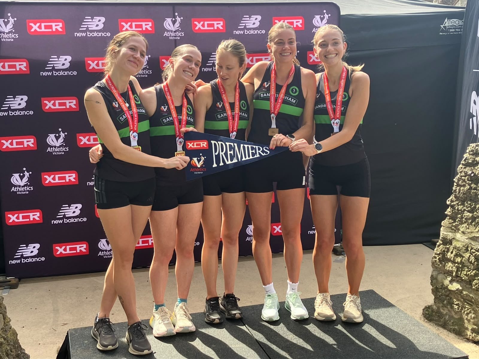 Sandringham’s women with their medals and the Premier Division pennant at the Tan Relays