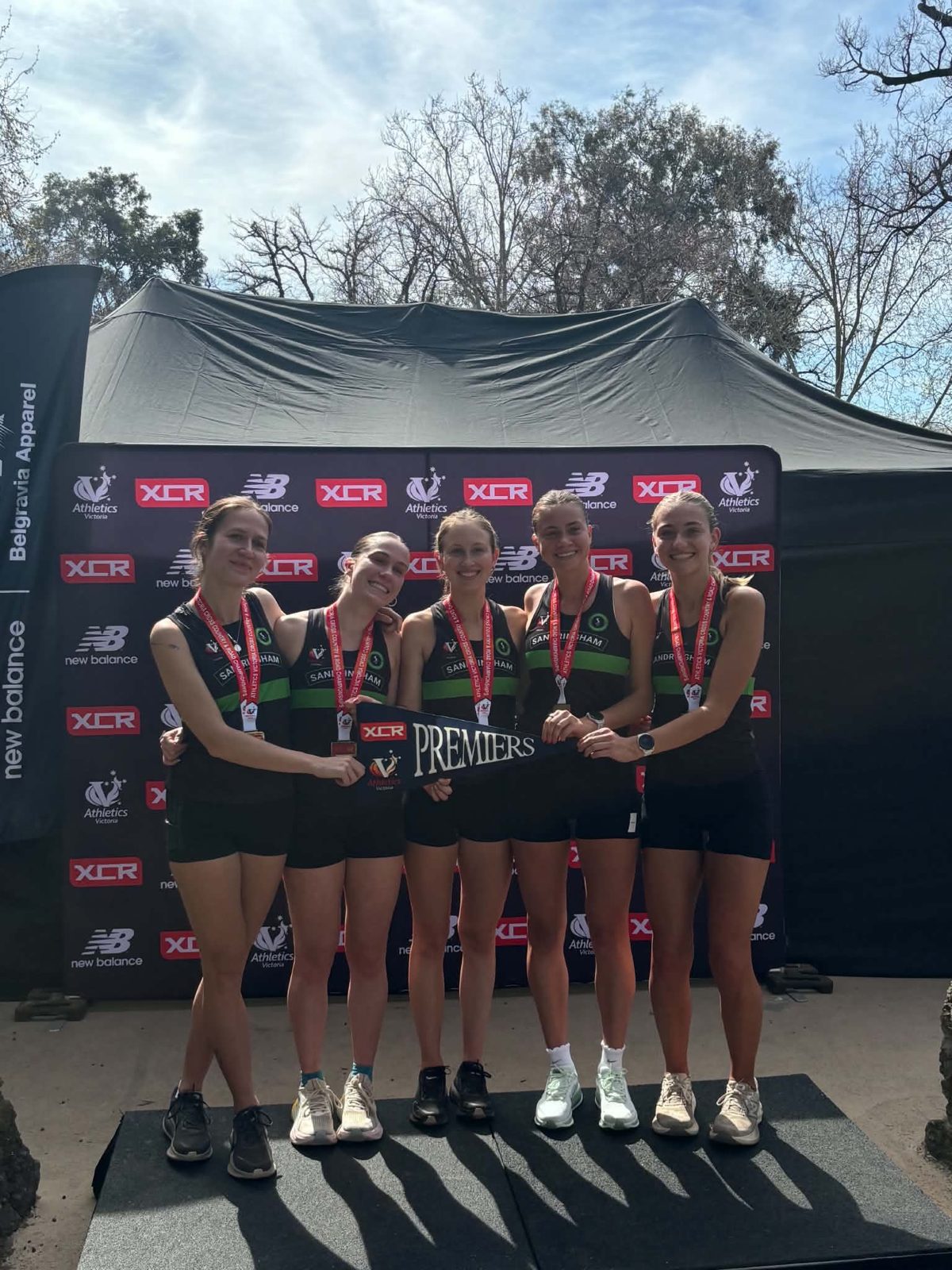 The Sandringham women’s team on the podium with their medals and pennant