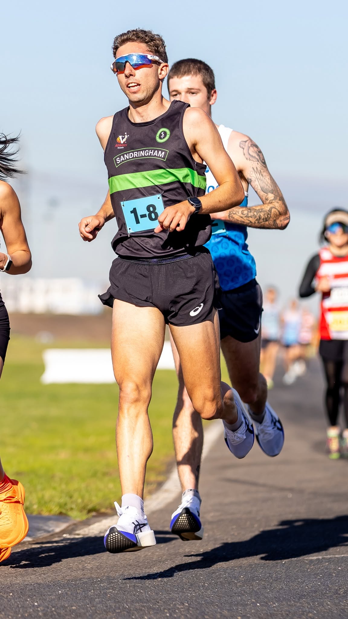 Sandy runner powering along a road relay leg at Calder Raceway