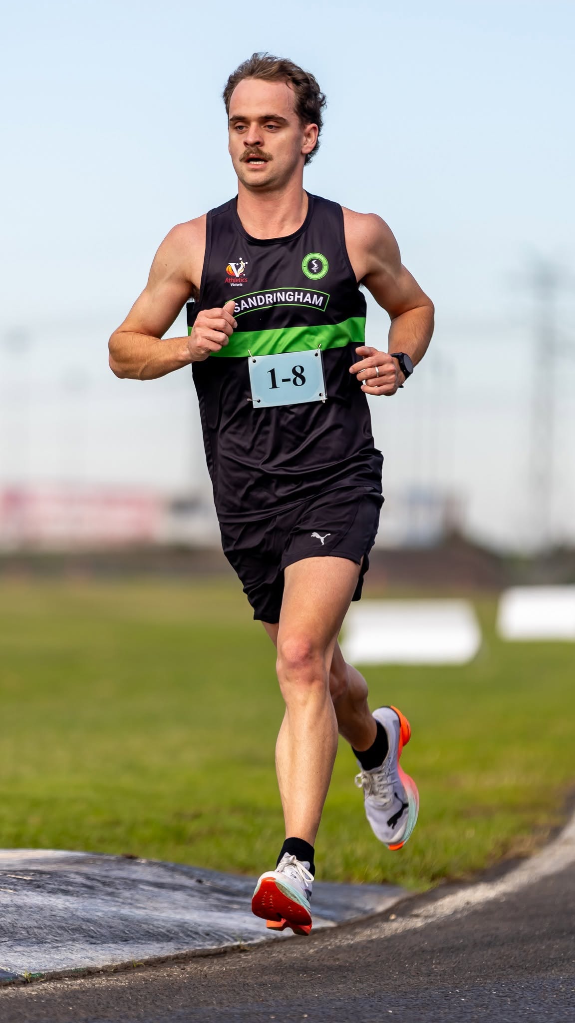 Sandy runner rounding the bend on the road relay at Calder Raceway