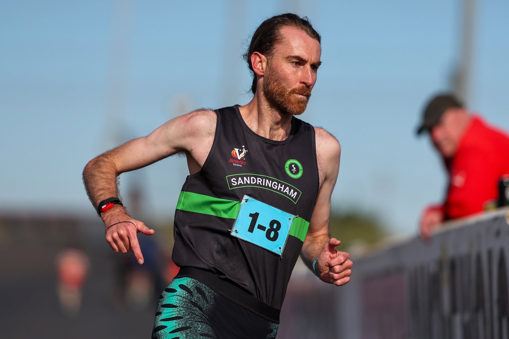 Sandy runner pushing hard on his relay leg at Calder Raceway
